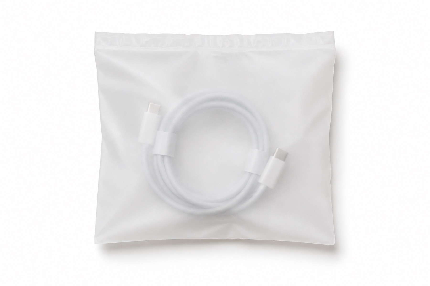A translucent frosted-white compostable anti-static bag with a coiled USB-C cable faintly visible inside, on white.